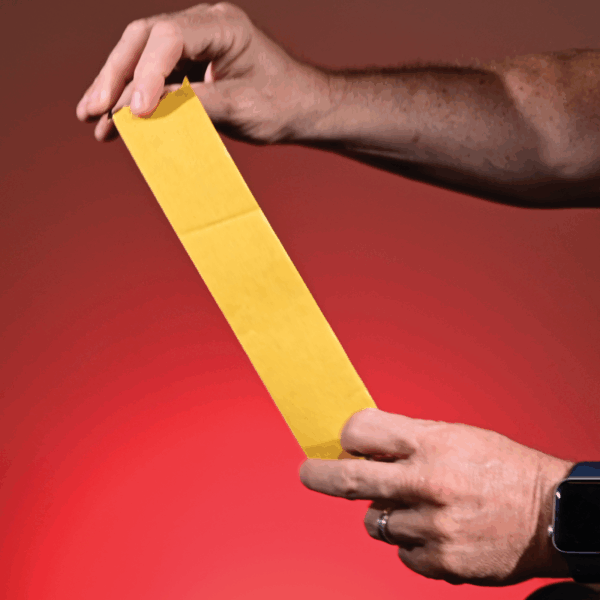 The yellow release liner on the adhesive side of the scrim foam tape.